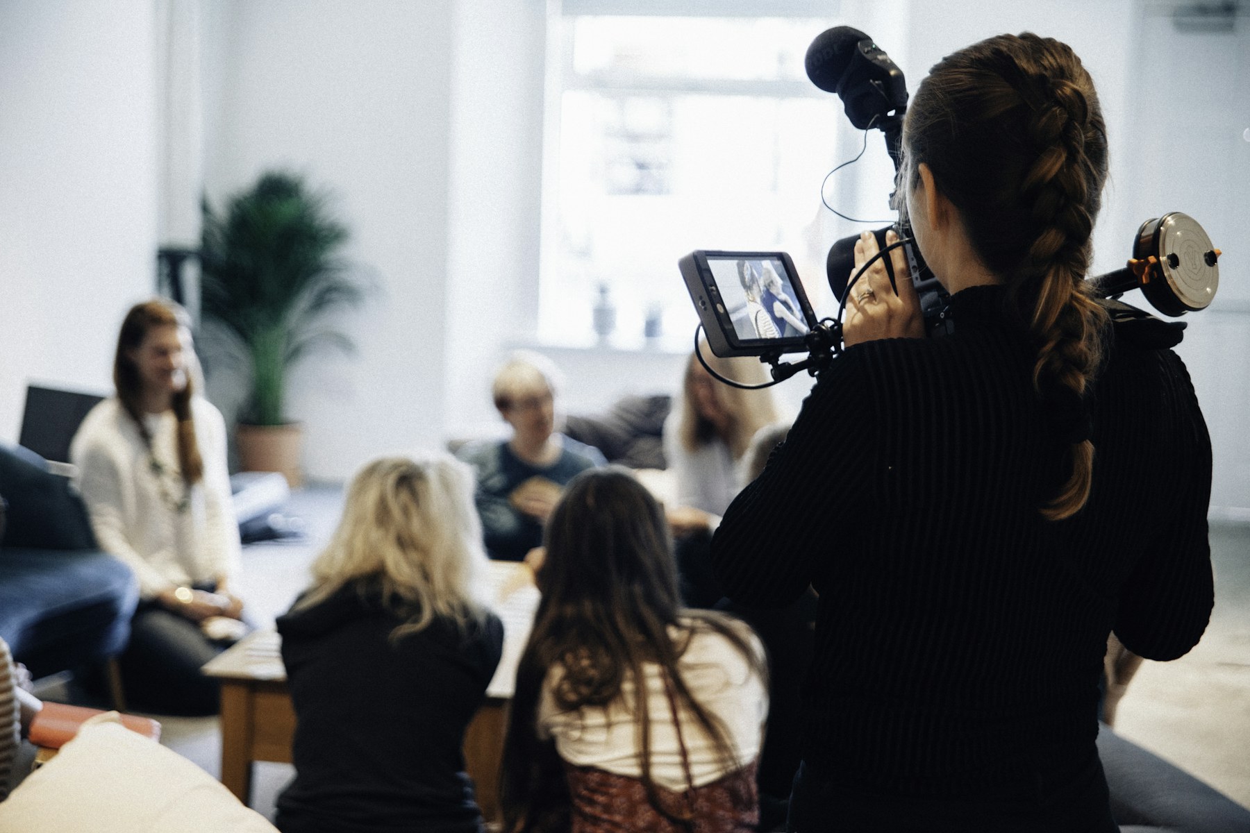 A professional video crew filming a presenter at a company location